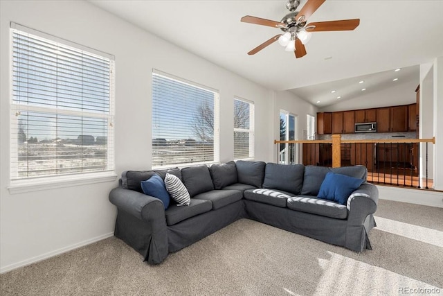 living room featuring ceiling fan, light colored carpet, and lofted ceiling