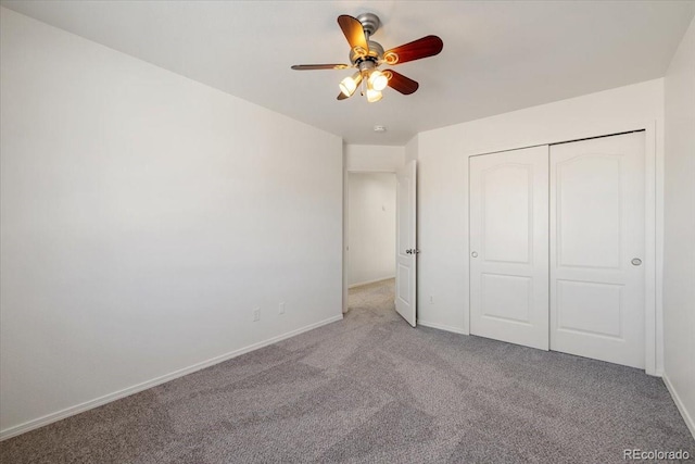 unfurnished bedroom with ceiling fan, light carpet, and a closet