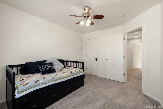 carpeted bedroom featuring ceiling fan