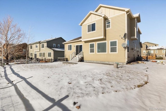 snow covered property featuring central AC unit