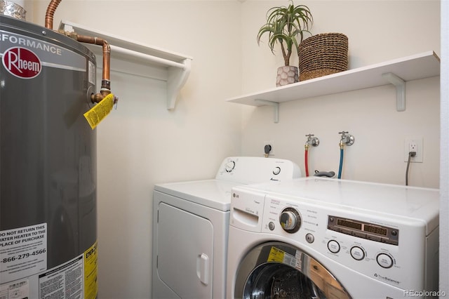 laundry area featuring gas water heater, separate washer and dryer, and laundry area