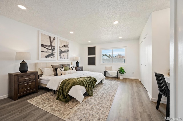 bedroom featuring recessed lighting, wood finished floors, and a textured ceiling