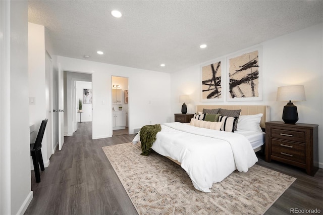 bedroom featuring connected bathroom, baseboards, dark wood finished floors, recessed lighting, and a textured ceiling