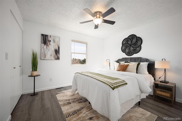 bedroom featuring visible vents, a textured ceiling, wood finished floors, and a ceiling fan