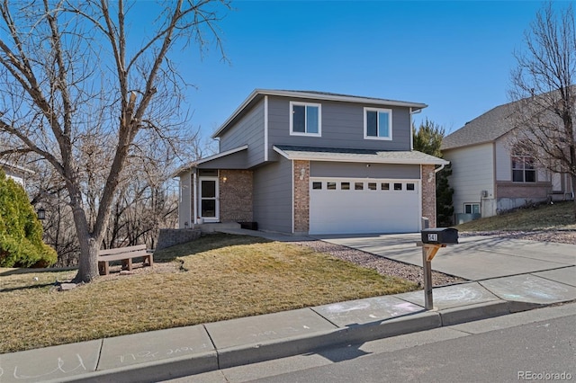 view of front of property with brick siding, driveway, a front yard, and a garage