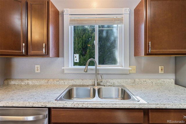 kitchen with stainless steel dishwasher, a healthy amount of sunlight, and a sink