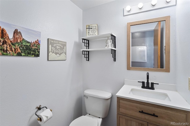 bathroom featuring toilet and vanity