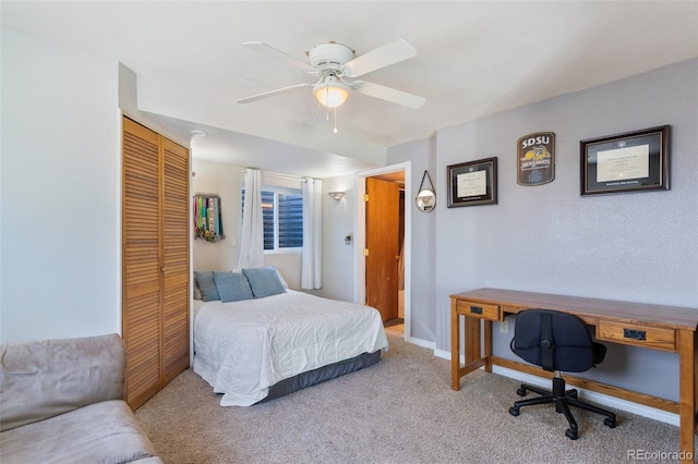 carpeted bedroom with baseboards, a closet, and ceiling fan