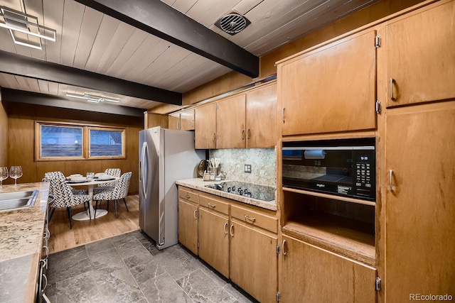 kitchen featuring sink, wood ceiling, black appliances, beam ceiling, and backsplash