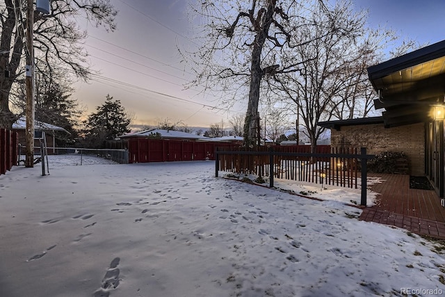 yard layered in snow featuring a wooden deck