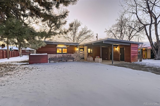 view of snow covered rear of property