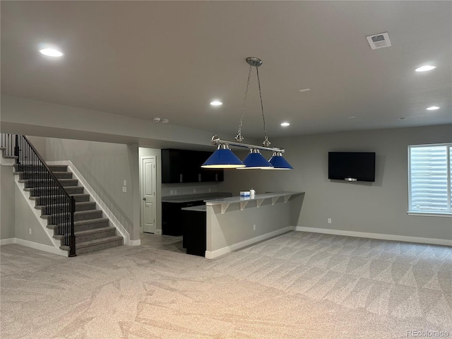 kitchen featuring visible vents, a peninsula, recessed lighting, light colored carpet, and open floor plan