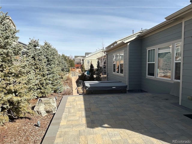 view of patio / terrace featuring a covered hot tub