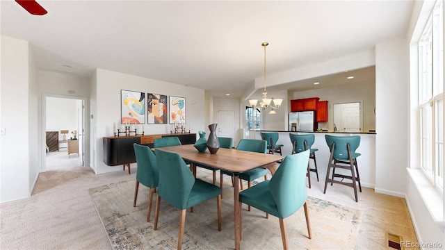 dining area featuring recessed lighting, visible vents, a notable chandelier, and light colored carpet