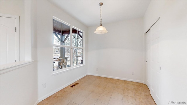 unfurnished dining area featuring visible vents and baseboards