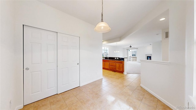 interior space with light tile patterned floors, visible vents, and baseboards