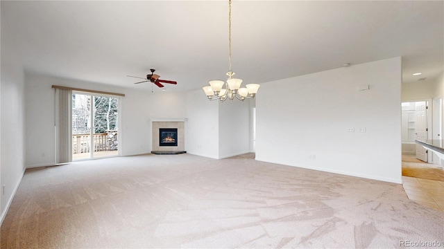 unfurnished living room featuring light carpet, a glass covered fireplace, and baseboards