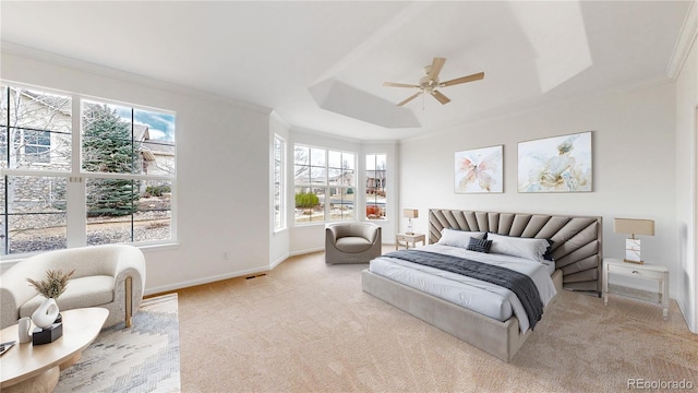 bedroom with multiple windows, a raised ceiling, and crown molding