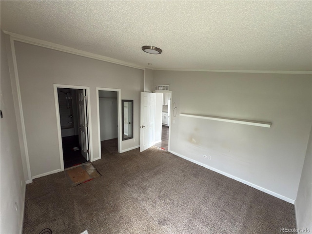 201 Valdai St, Brighton, CO 80603 - unfurnished bedroom with a textured ceiling, carpet flooring, a closet, crown molding, and a walk in closet