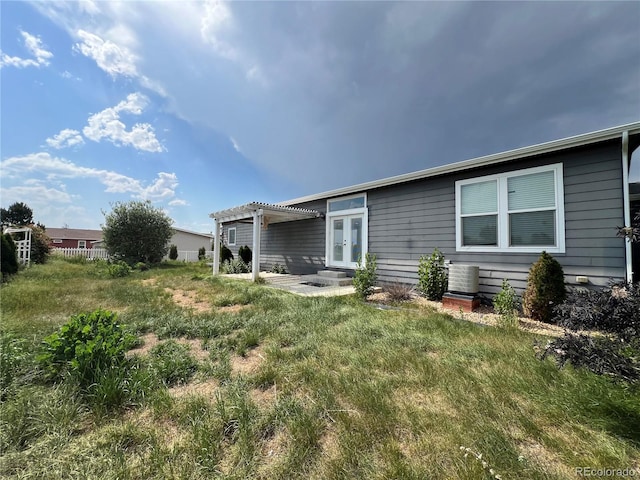 6100 Bluestem Unit 238, Frederick, CO 80530 - rear view of house with a pergola and french doors