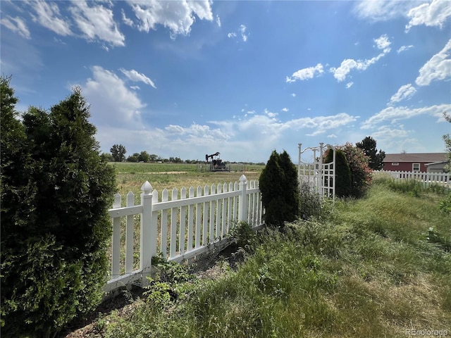 6100 Bluestem Unit 238, Frederick, CO 80530 - gate featuring a view of rural / pastoral area