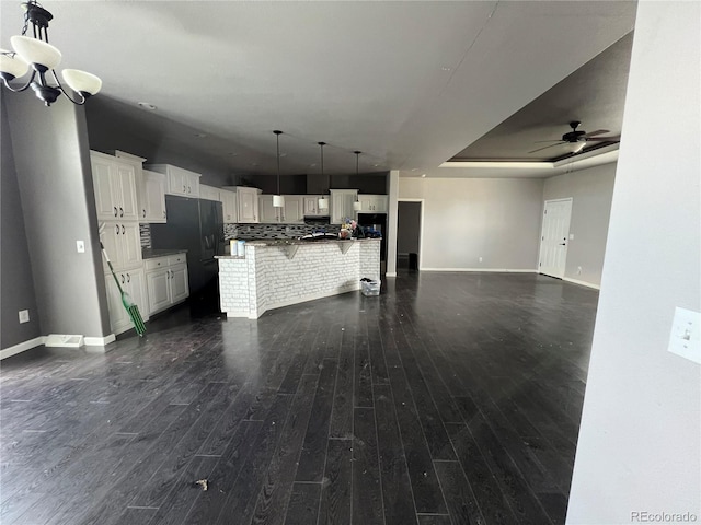 6100 Bluestem Unit 238, Frederick, CO 80530 - kitchen with open floor plan, white cabinets, a kitchen breakfast bar, and a ceiling fan