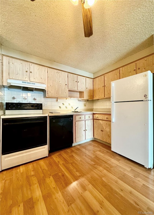 kitchen with light hardwood / wood-style flooring, white appliances, and light brown cabinetry