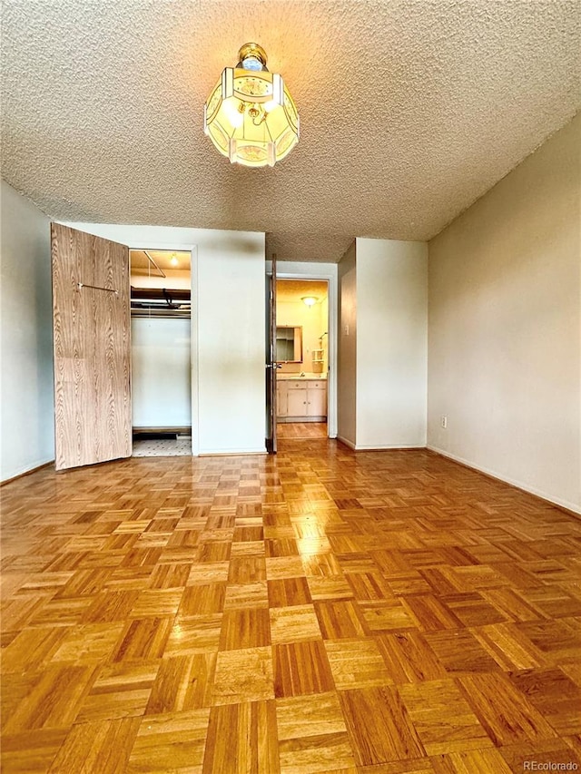 interior space with light parquet flooring and a textured ceiling