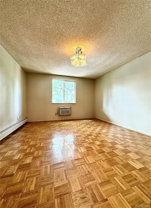 unfurnished room with a textured ceiling, a wall mounted AC, and light parquet floors