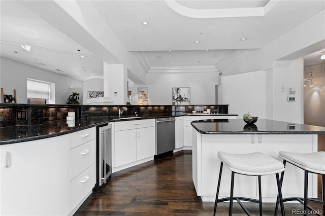 kitchen featuring a large island, a sink, dark wood-style floors, wine cooler, and stainless steel dishwasher