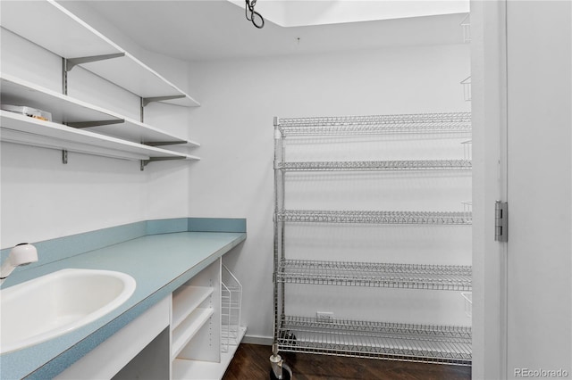 interior space with wood finished floors and a sink