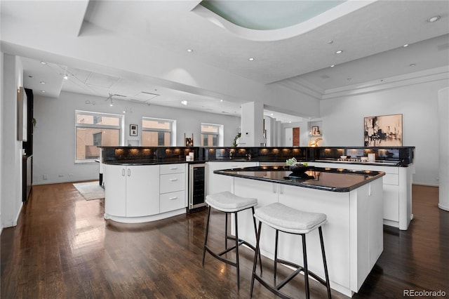 kitchen featuring wine cooler, modern cabinets, dark wood-style floors, and a kitchen island