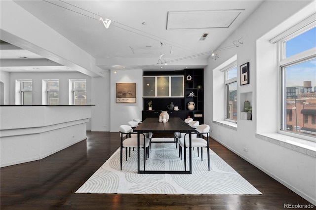 dining area featuring wood finished floors and baseboards