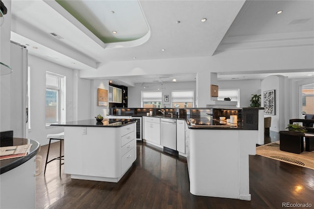 kitchen with stainless steel dishwasher, a large island, dark wood-style flooring, dark countertops, and wine cooler