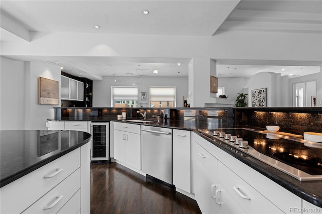 kitchen featuring dark wood-type flooring, dishwasher, wine cooler, a sink, and black electric stovetop