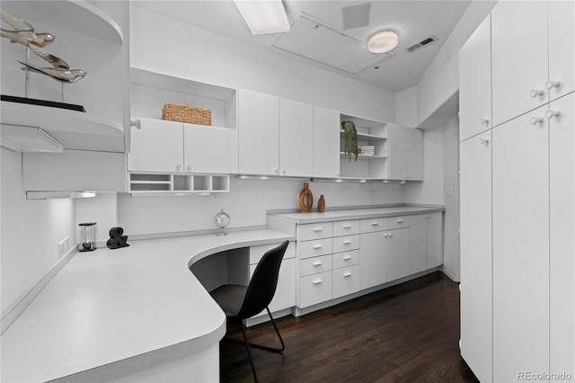 home office with dark wood-style flooring and visible vents