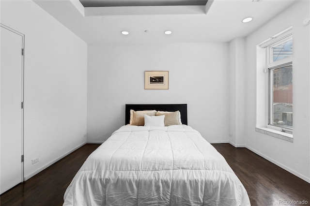 bedroom featuring wood finished floors, baseboards, and recessed lighting