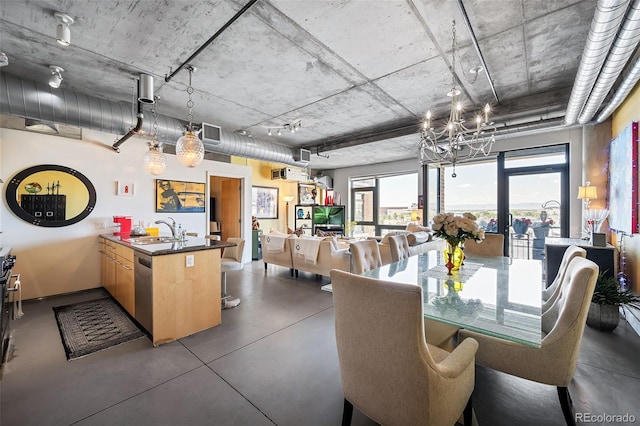 dining area with sink and a notable chandelier