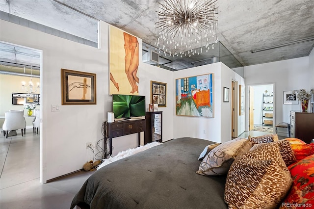 bedroom with concrete floors and a chandelier