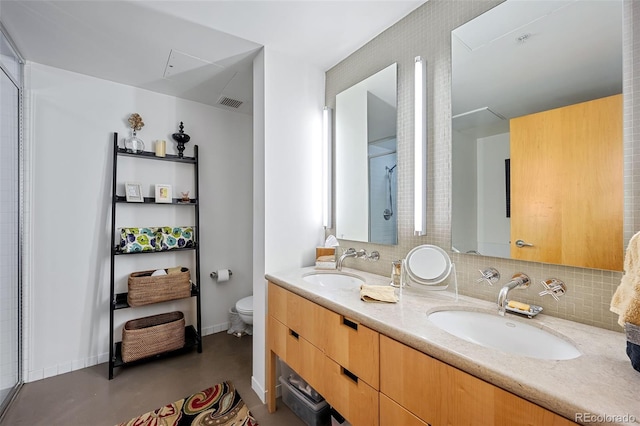 bathroom with vanity, concrete flooring, and toilet