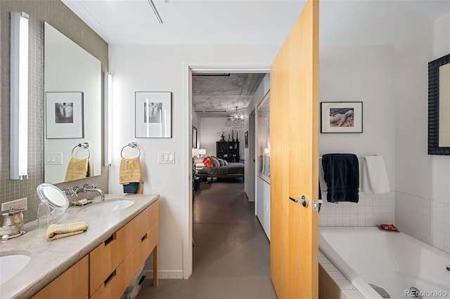 bathroom featuring vanity and a relaxing tiled tub