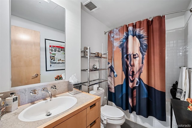 full bathroom with vanity, tile walls, shower / tub combo with curtain, and toilet