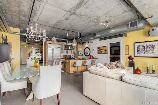 2100 16th St Unit 606, Denver, CO 80202 - living room featuring finished concrete flooring, an inviting chandelier, and visible vents
