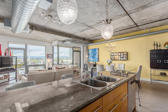2100 16th St Unit 606, Denver, CO 80202 - kitchen featuring a sink, brown cabinets, finished concrete floors, dishwasher, and a chandelier