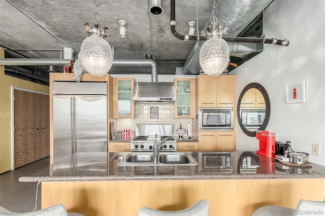 2100 16th St Unit 606, Denver, CO 80202 - kitchen with built in appliances, glass insert cabinets, a sink, a kitchen breakfast bar, and dark stone countertops