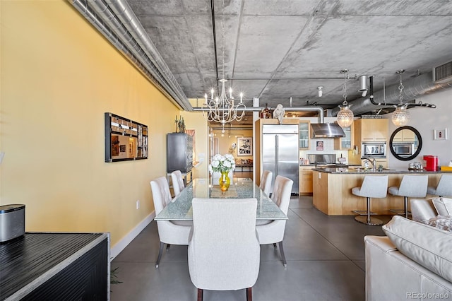 2100 16th St Unit 606, Denver, CO 80202 - dining room featuring finished concrete floors, a chandelier, and baseboards