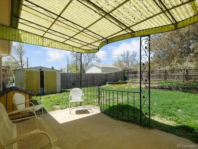 view of patio / terrace featuring an outbuilding, a shed, and a fenced backyard