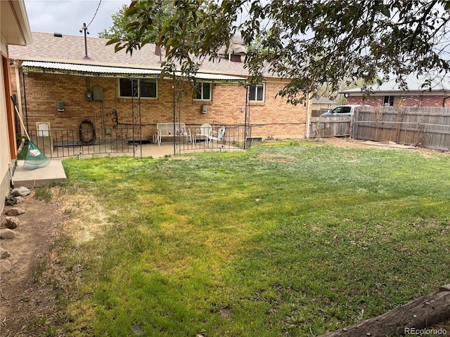 view of yard with a patio and a fenced backyard