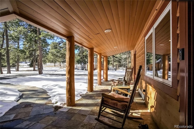 snow covered patio with covered porch