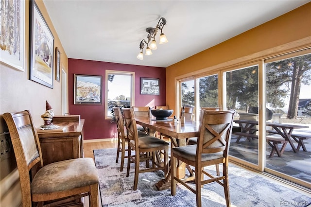 dining area with plenty of natural light, a chandelier, and light hardwood / wood-style floors